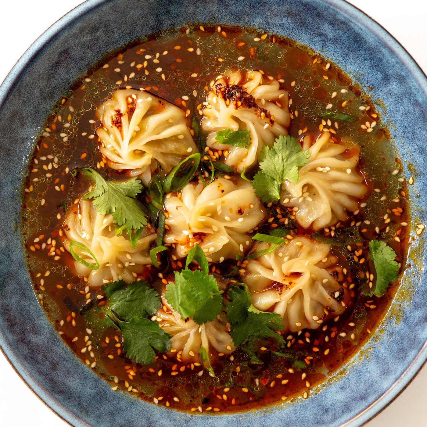 Dumpling soup with chilli oil, sesame and fresh coriander